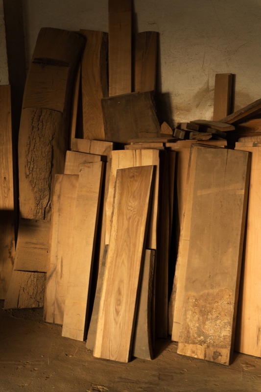 Holzbohlen werden vor der Verarbeitung in der Werkstatt ausgewählt